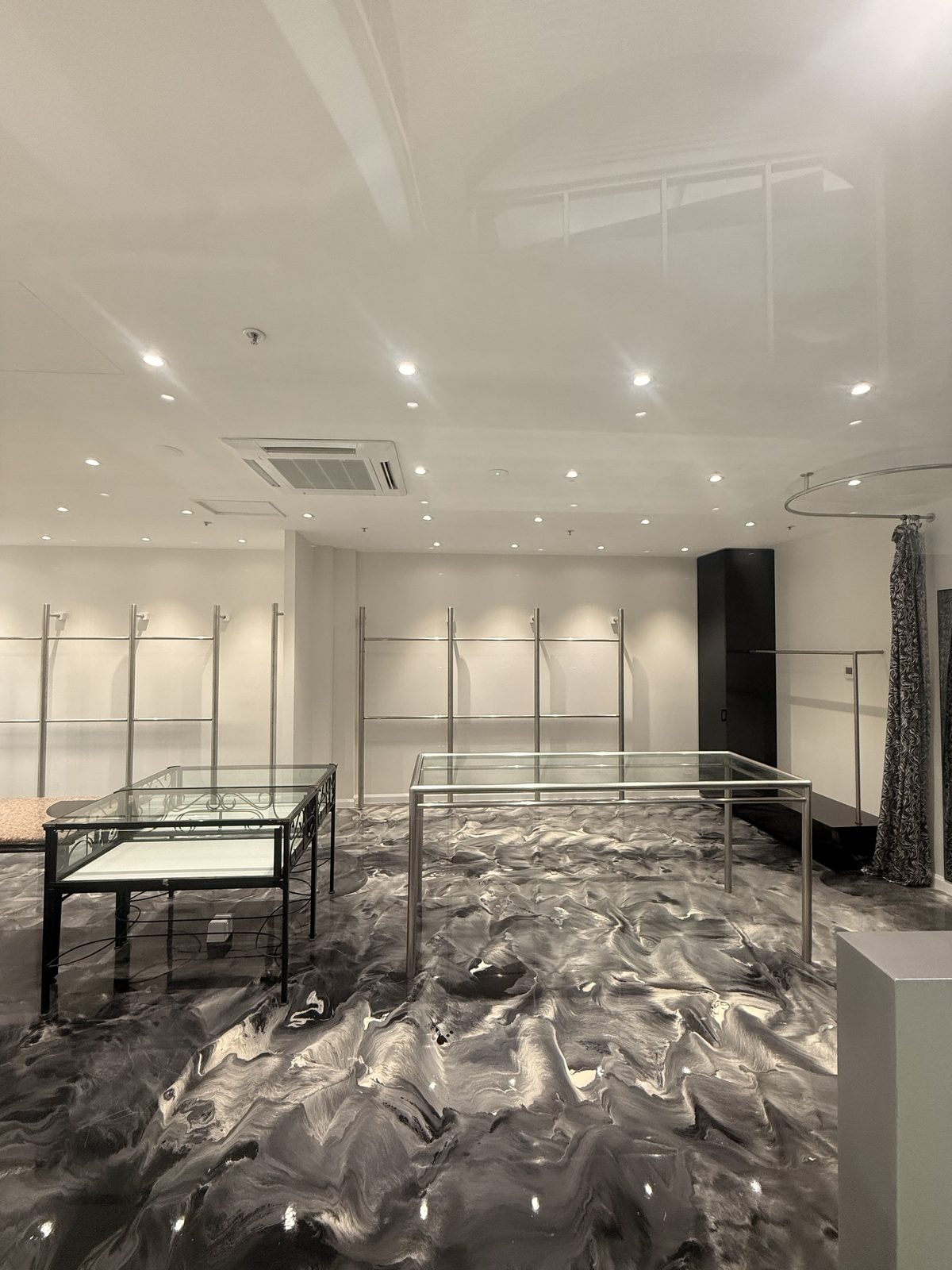 The rear of the store with fitting area and display rails