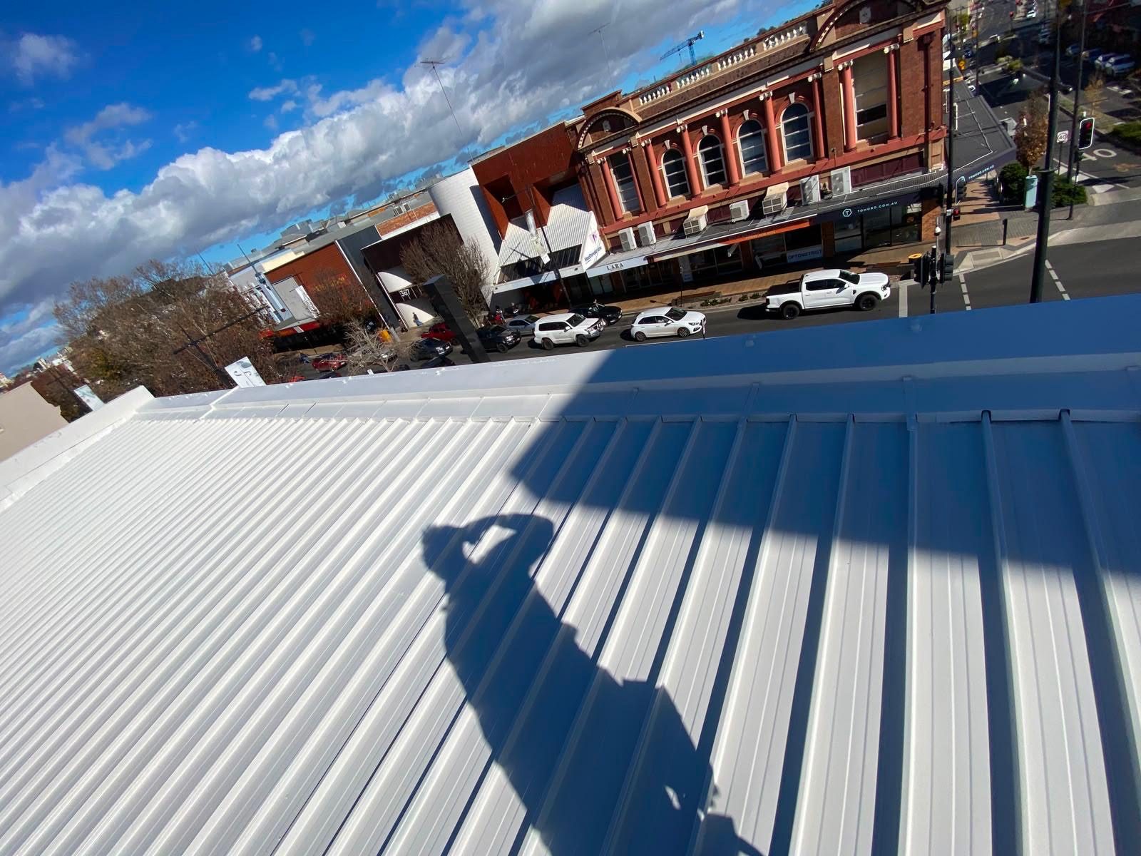 Completed white membrane roof at 368 Ruthven Street with the Toowoomba heritage streetscape beyond